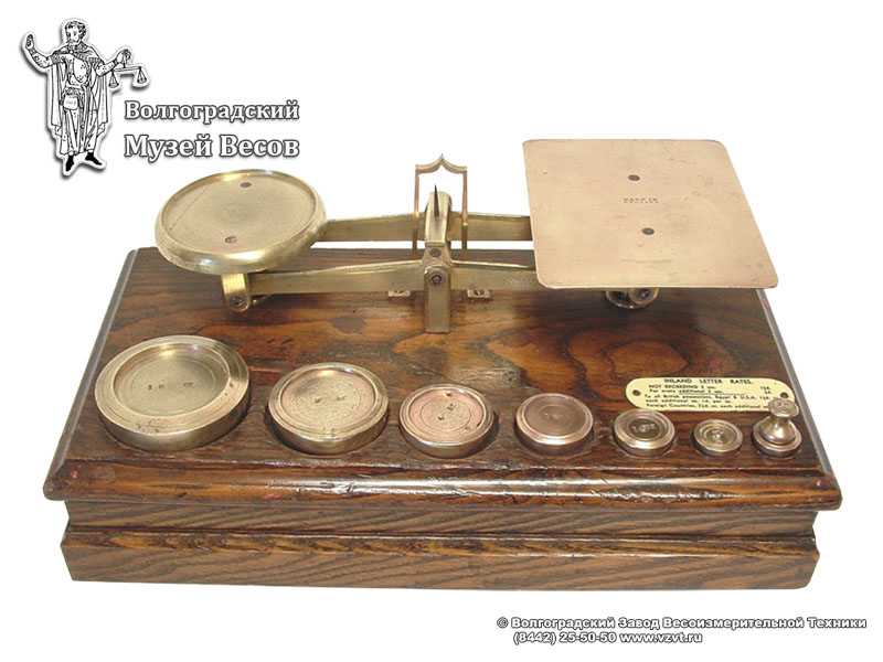 Letter balance in a wooden casing, with weights. England, the first half of the XX century.