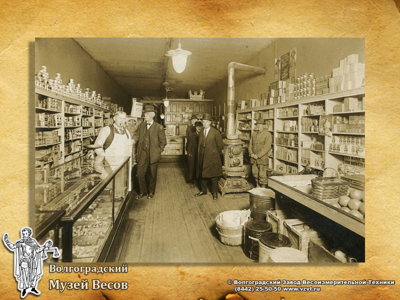 Interior of the shop. Weighing sweets. Old-time photograph depicting scales.