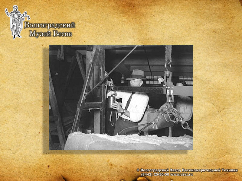 Weighing of a bale with scalebeam. Retro photo.