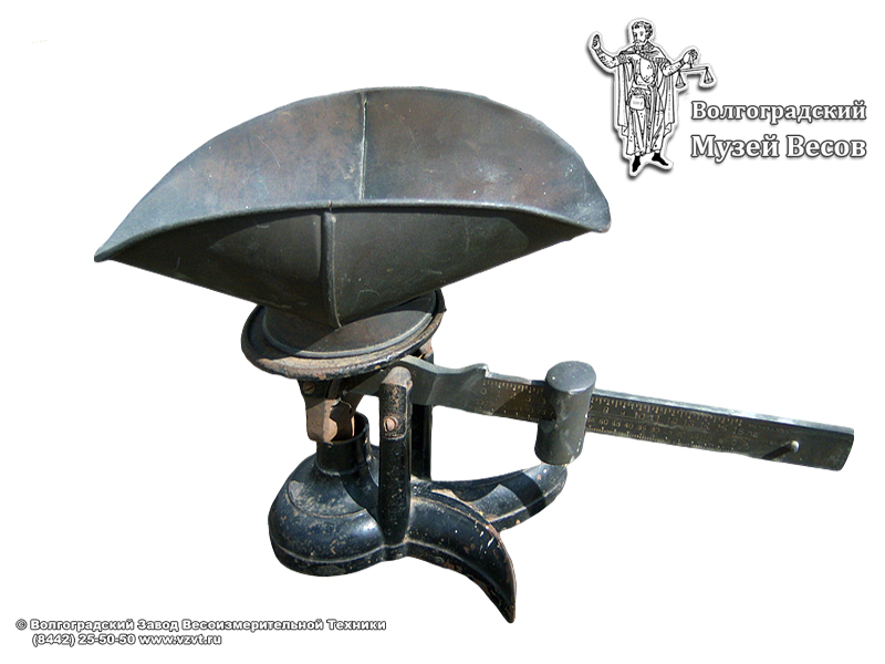 Trade scales in a cast iron casing with a movable weight. USA, the early XX century.
